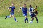 The Family School’s Yves Kipollongo contests the ball with a couple of Lions.