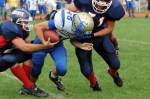 Tri-Valley’s defensive linemen Nick Corigilano and Brian Edwards stop Doug Lewis.