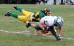 Eldred’s Geno Jones makes a flying tackle on Spackenkill’s Mark Lewis, assisted by another defensive lineman.