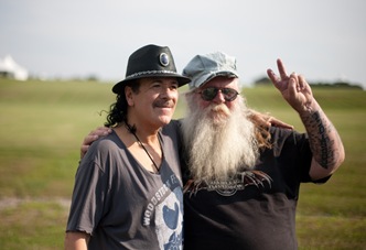 7/17/10 Bethel, NY. "This is ground zero for peace and love."-Carlos Santana-7/17/10 Bethel, NY.  Before his sold out show Carlos Santana poses at the site of the 1969 Woodstock festival at Bethel Woods Center for the Arts, with Duke Devlin Site Intrepretor at Bethel Woods.  MICHAEL D. BLOOM/Bethel Woods mb@michaelbloomphoto.com 