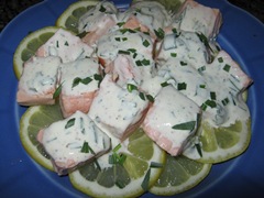 Poached salmon on lemon slices with tarragon mustard mayonnaise