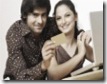 portrait-young-couple-sitting-front-laptop-with-credit-card