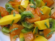 Fruit salad of mango, kiwi, and oranges with mint