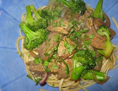 Close up of beef with broccoli on udon noodles